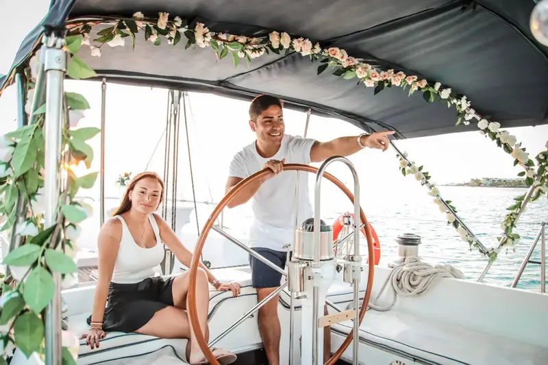 At the helm of the sailboat